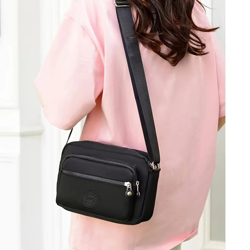 Lightweight Nylon Chic Crossbody Bag for Women - Adjustable Strap, Zip Closure, Tassel Accent, Solid Color