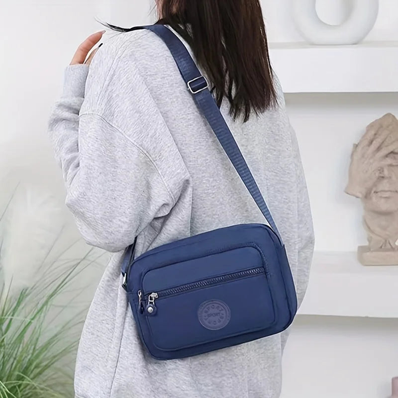 Lightweight Nylon Chic Crossbody Bag for Women - Adjustable Strap, Zip Closure, Tassel Accent, Solid Color
