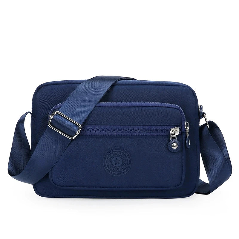 Lightweight Nylon Chic Crossbody Bag for Women - Adjustable Strap, Zip Closure, Tassel Accent, Solid Color