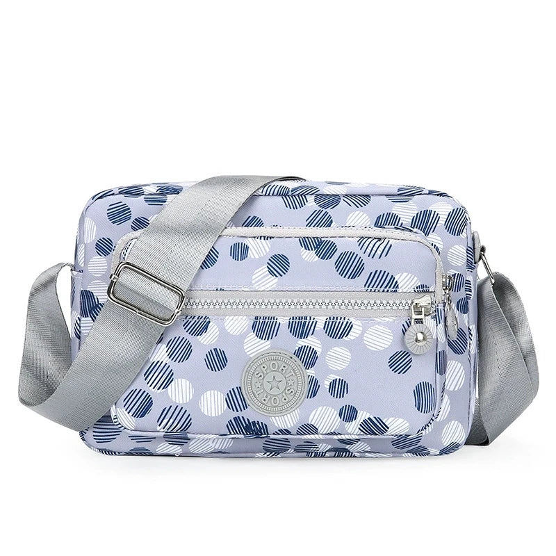 Lightweight Nylon Chic Crossbody Bag for Women - Adjustable Strap, Zip Closure, Tassel Accent, Solid Color