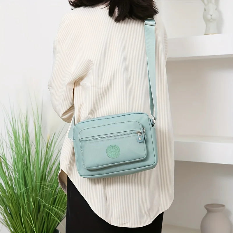 Lightweight Nylon Chic Crossbody Bag for Women - Adjustable Strap, Zip Closure, Tassel Accent, Solid Color