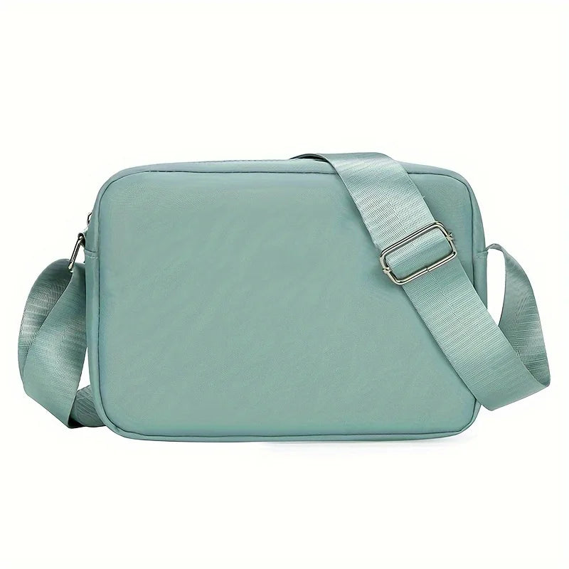 Lightweight Nylon Chic Crossbody Bag for Women - Adjustable Strap, Zip Closure, Tassel Accent, Solid Color