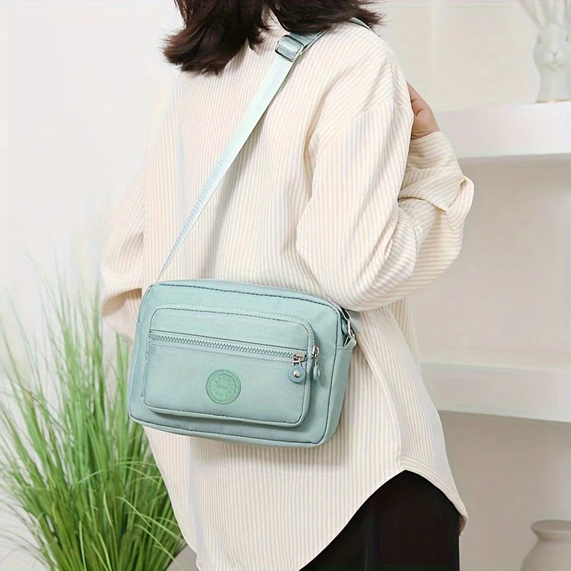 Lightweight Nylon Chic Crossbody Bag for Women - Adjustable Strap, Zip Closure, Tassel Accent, Solid Color